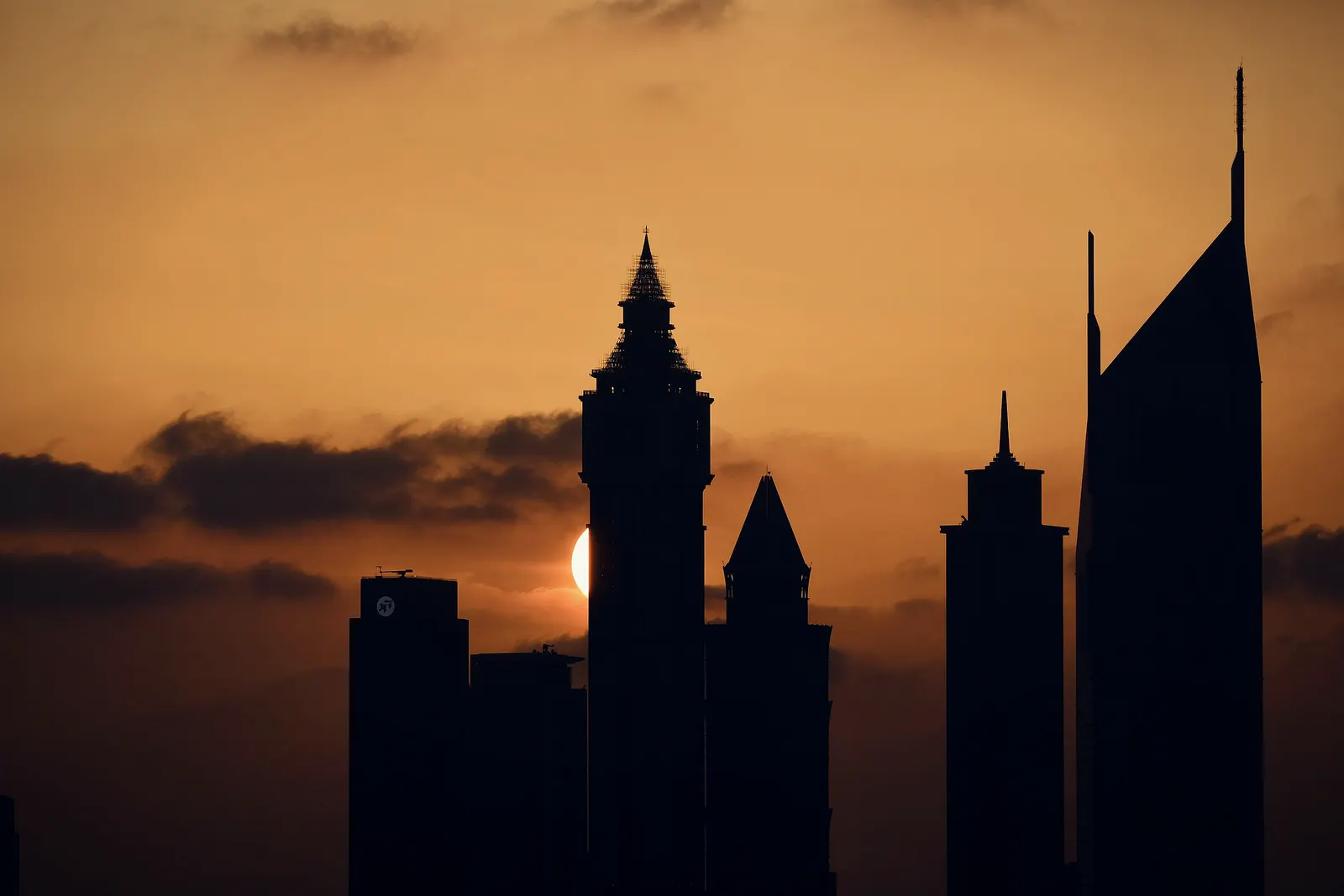 Dubai skyline in silhouette at sunset