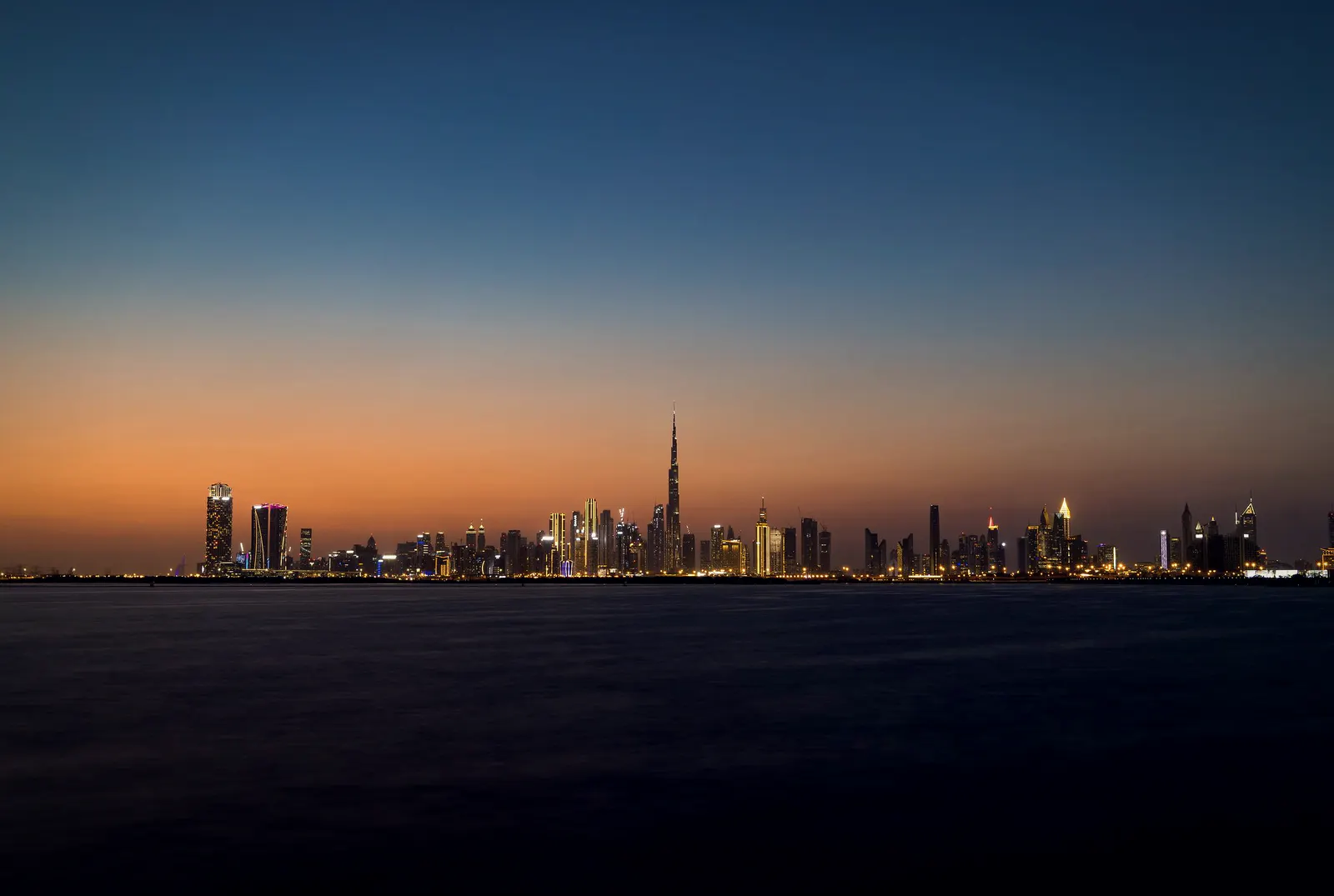 Dubai skyline across the water at dusk